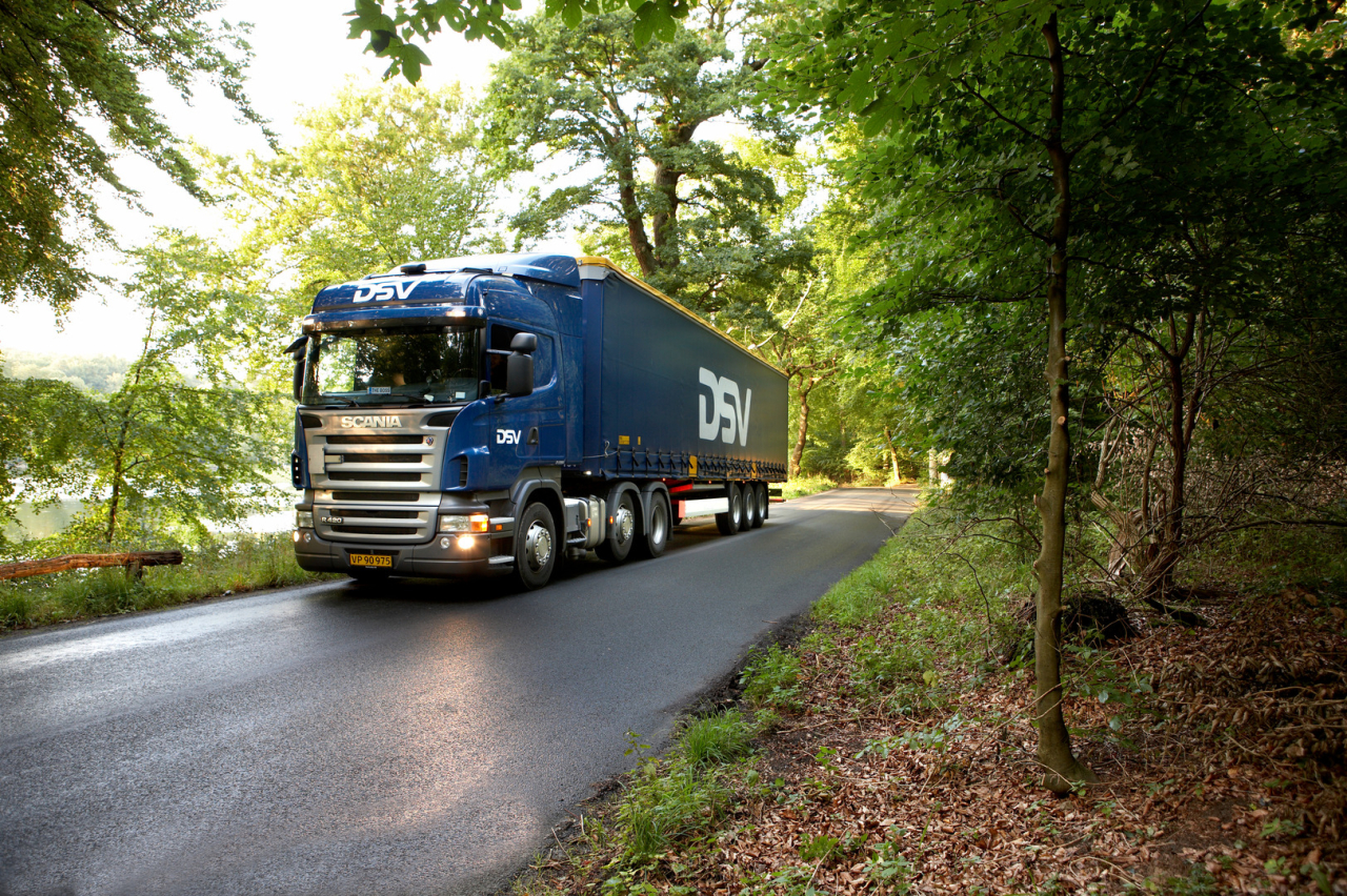 A DSV truck is driving on a forest road.