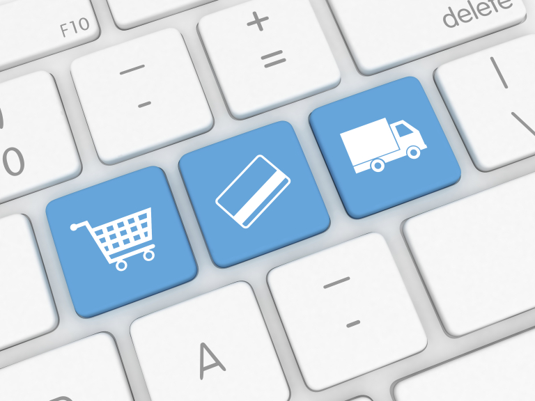 A computer keyboard with blue keys showing a shopping cart, a payment card, and a delivery truck – representing e-commerce, payment, and shipping.